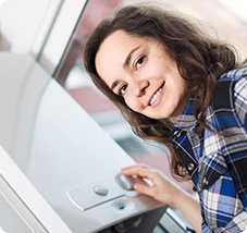 woman turning boiler dial