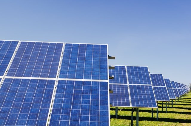 Solar panels installed in a sunny field for renewable energy generation.
