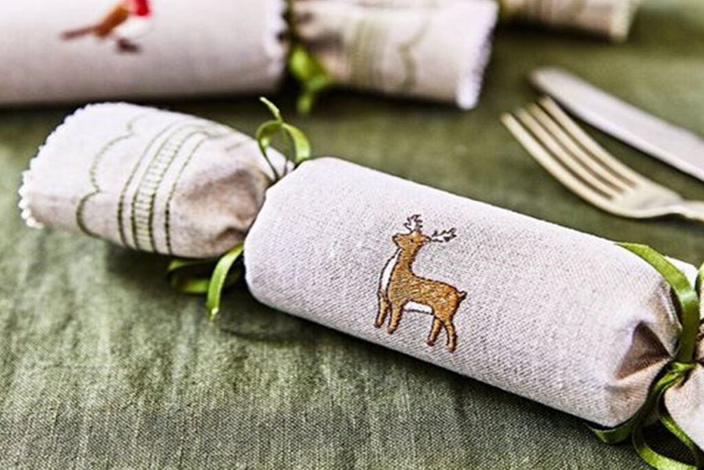 Eco-friendly Christmas cracker with reindeer embroidery, perfect for sustainable holiday celebration.