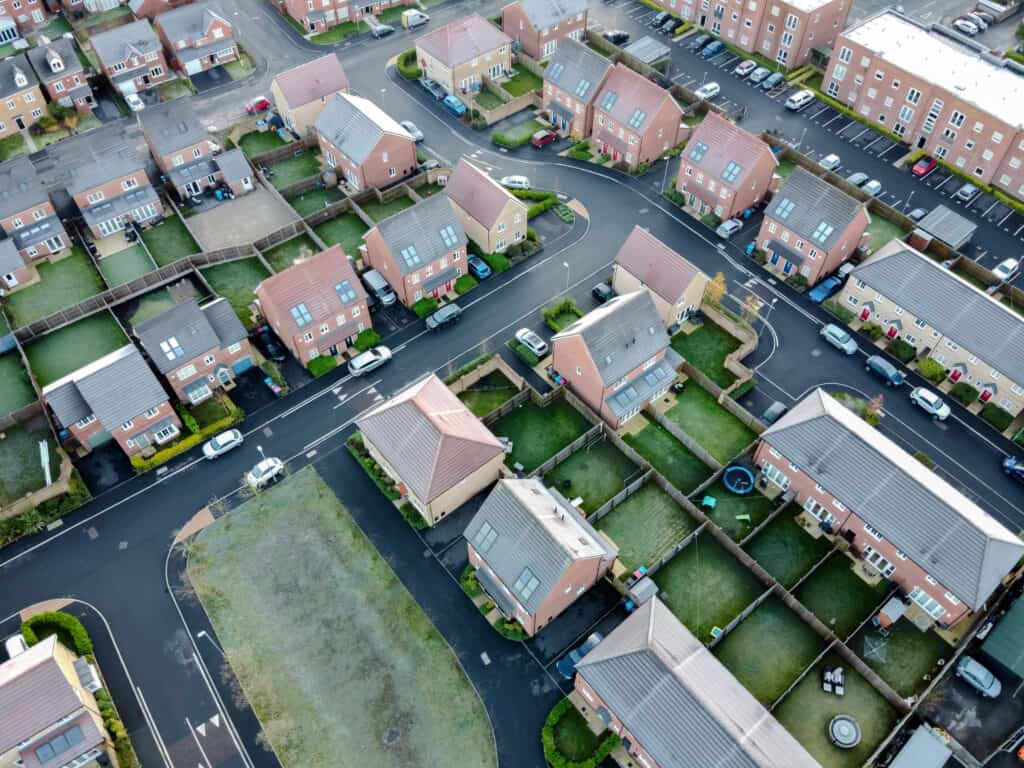 Aerial view of eco-friendly houses with solar panels and energy-efficient features.